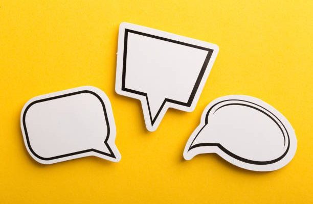Blank white speech bubble isolated on yellow background.